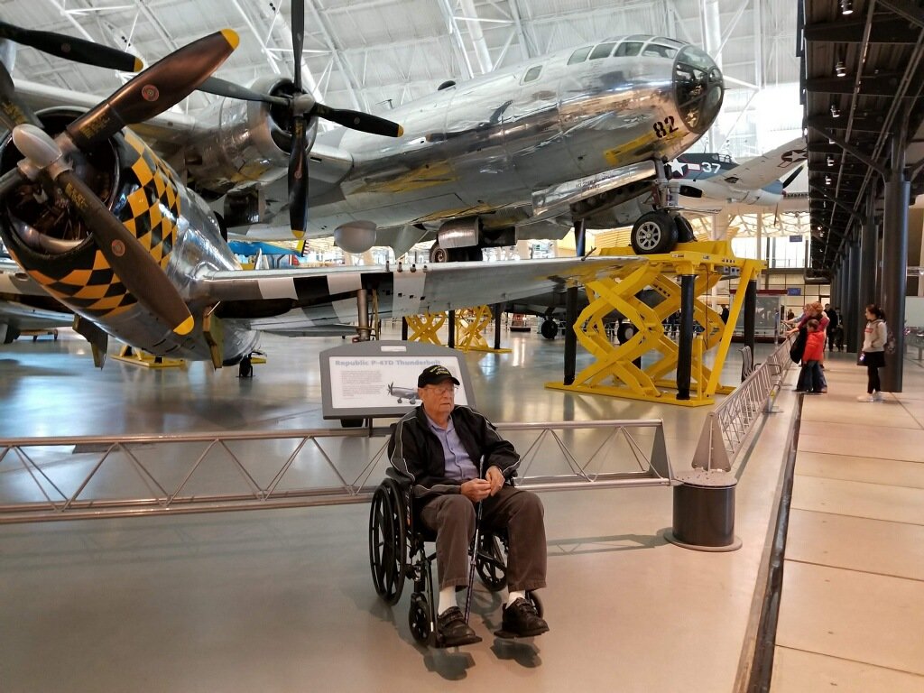 William Berger sits in front of the Enola Gay, the bomber that dropped the first atomic bomb on Japan.