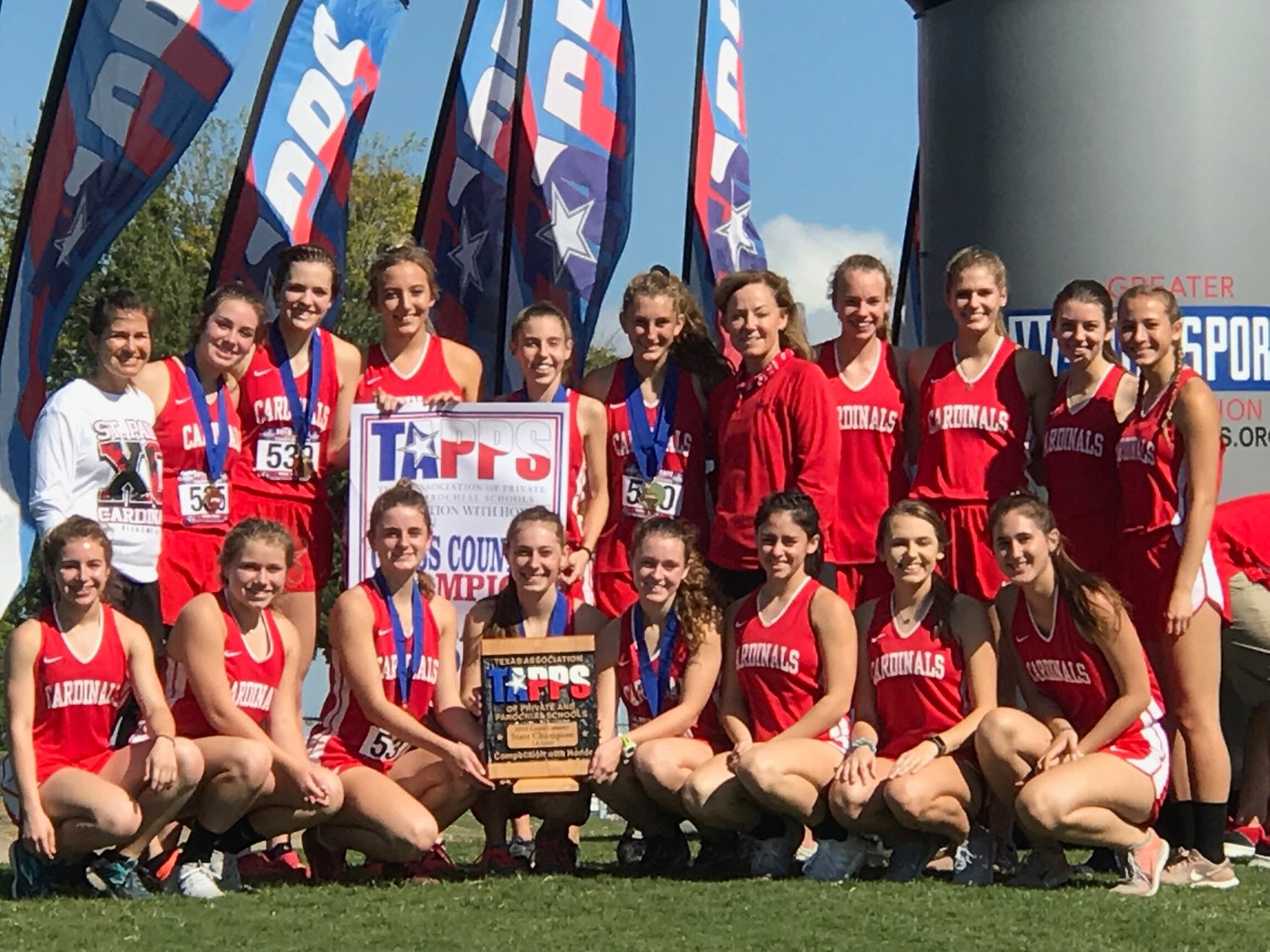 Pictured are the state champion Lady Cardinals. Kneeling down (from left) are Sarah Barecky, Taylor Wauson, Riley Johnson*, Hope Kapavik*, Bailey Blair*, Trinity Garza, Macy Grabarkievtz and Lauryn Kubenka. Top row (from left) are assistant Nicco Brown, Paige Brown*, Cameron Pesek*, Delynn Pesek, Juliana Davis*, Rebecca Wagner*, Head Coach Dana Beal, 
Grace Pilat, Holly Hull, Tristin Davis, Brooke Pesek. Names with an asterisk* are the race runners.