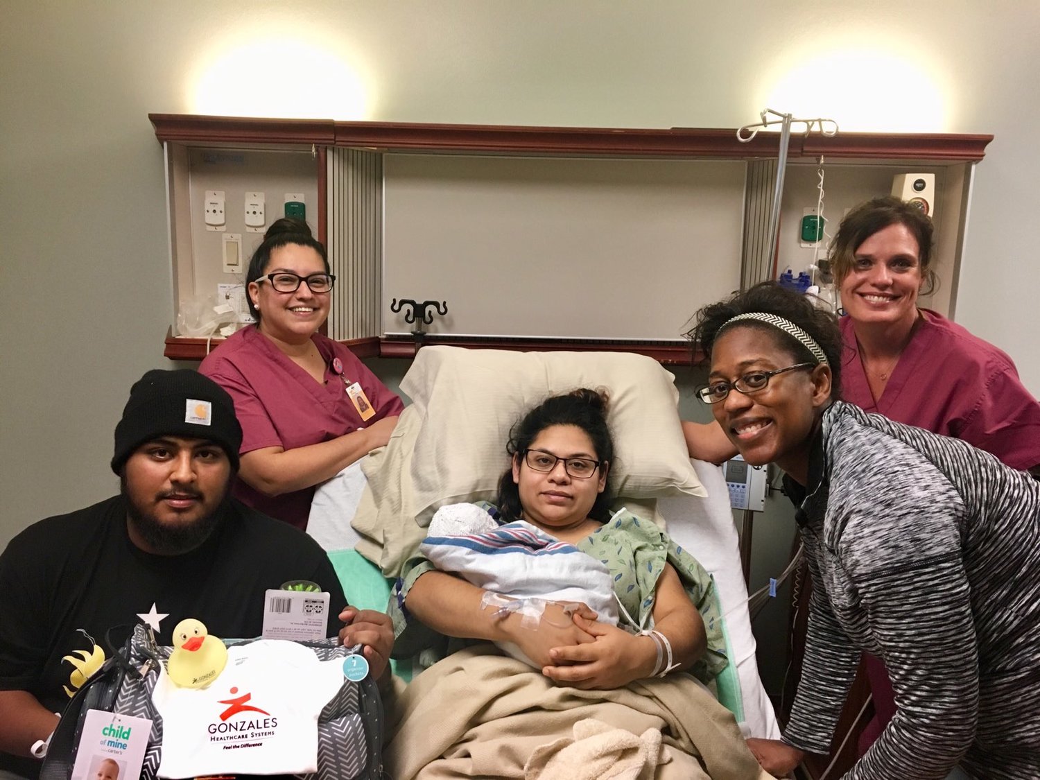 Pictured are Ramiro (father, bottom left), Amanda Sepulveda, LVN (top left), Yadira (mother) and Nalia (baby), Rikki Baldwin DO (bottom right) and Cindy Ackman, RN (top right).