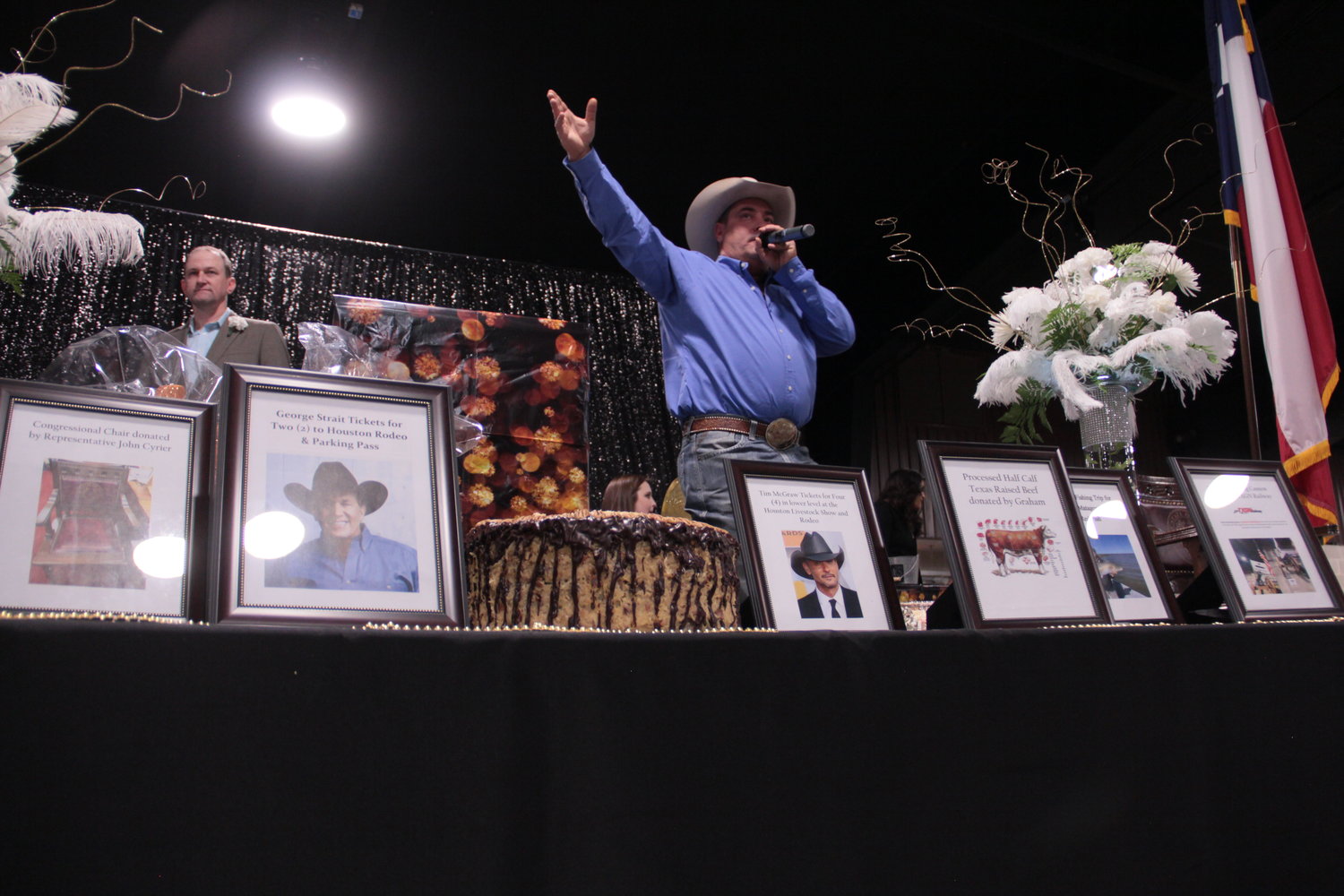 At Friday's annual chamber banquet, J.D. Shelton conducted a lively auction with assistance from emcee Egon Barthels. Items from Tim McGraw and George Strait tickets were available, as well as fishing trips, fresh beef, and a Texas Capitol chair donated by State Rep. John Cyrier.