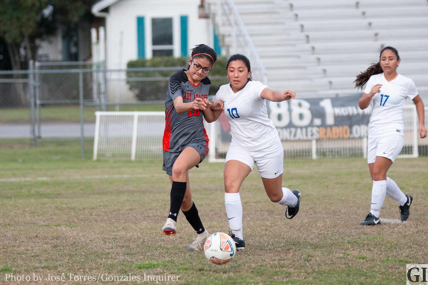Natalya Cruz (10, left) fights through a defender for possession in Gonzales’ 2-0 victory last Friday. The Lady Apaches moved to third place after their Senior Night win.