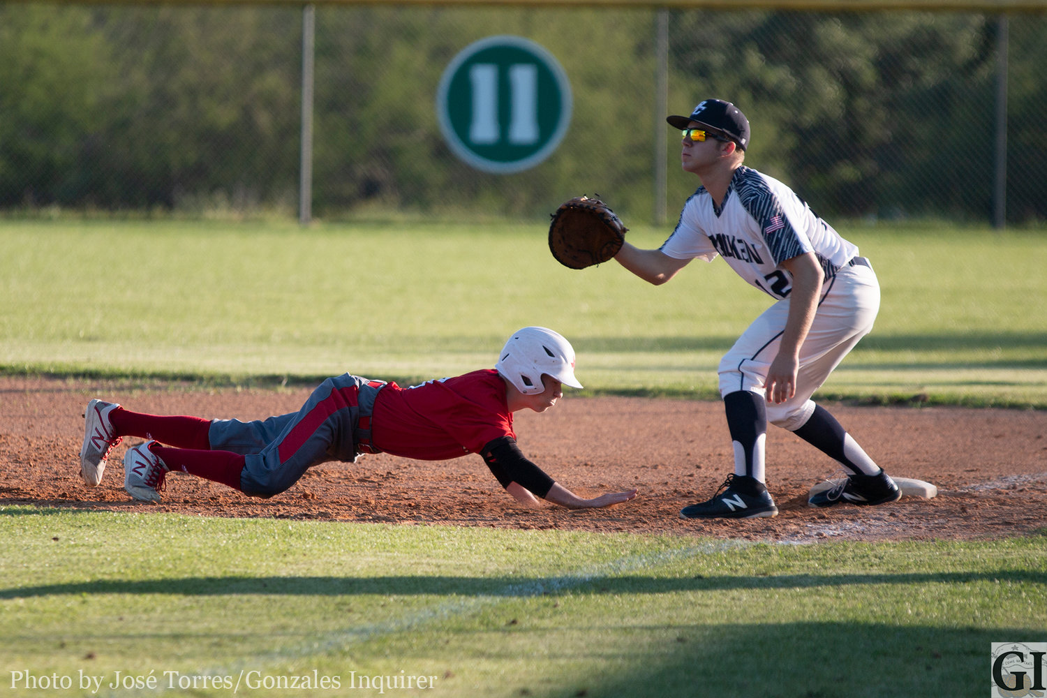 Sean Humes (3) slides to first.