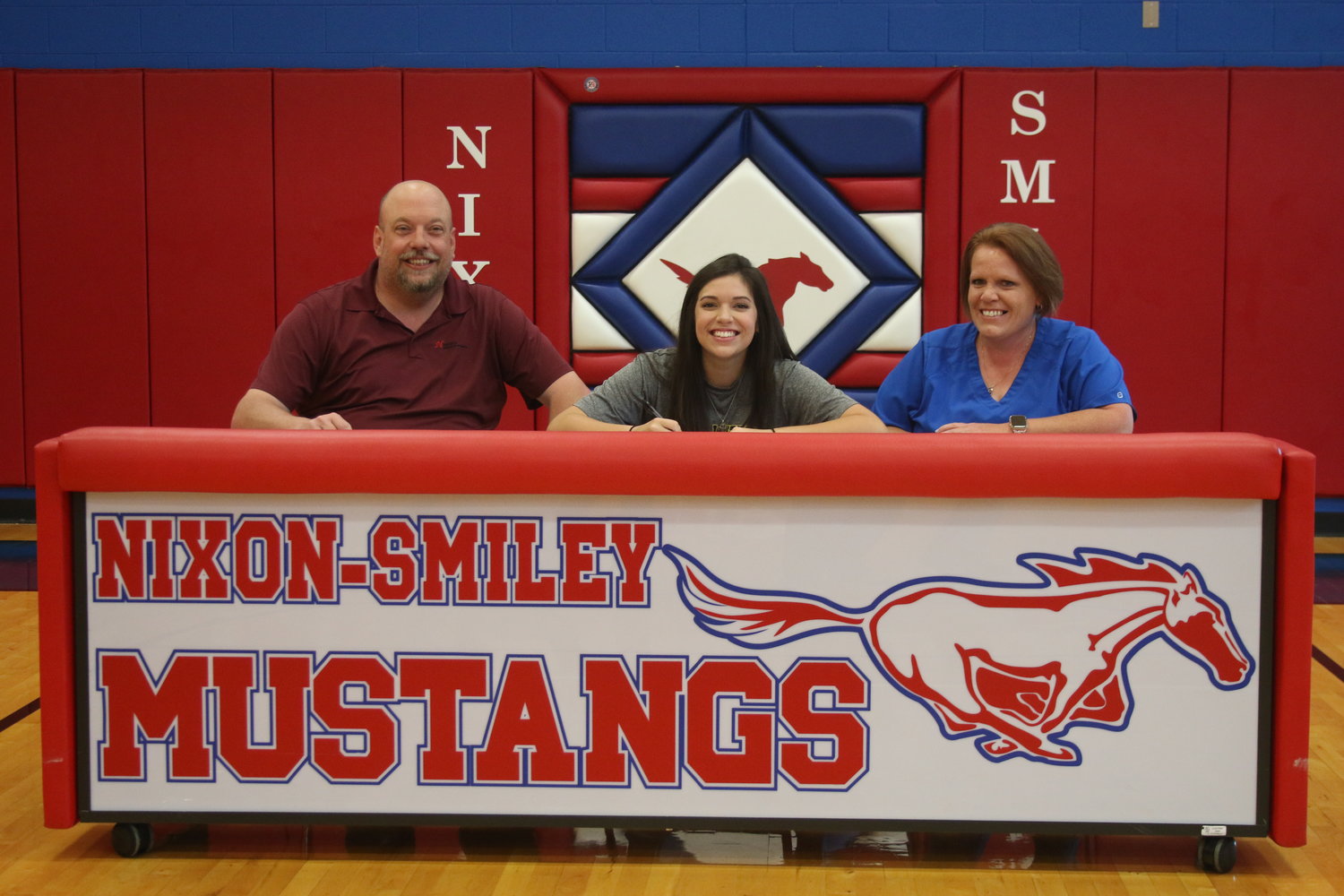Pictured (from left) are Merle Campbell, Caitlin Sandoval and Rebecca Campbell as Sandoval signs her letter of intent for Texas Lutheran University.