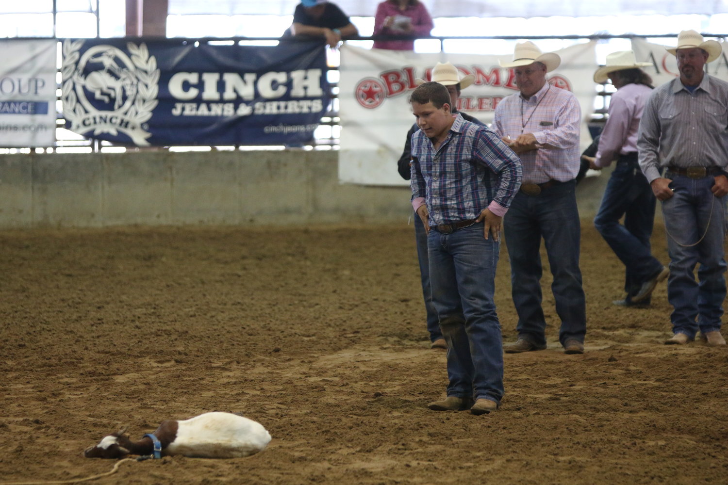 Hometown cowboy Barrett Shelton looks down at the goat he tied at the Texas Junior High Rodeo Association state finals last week.