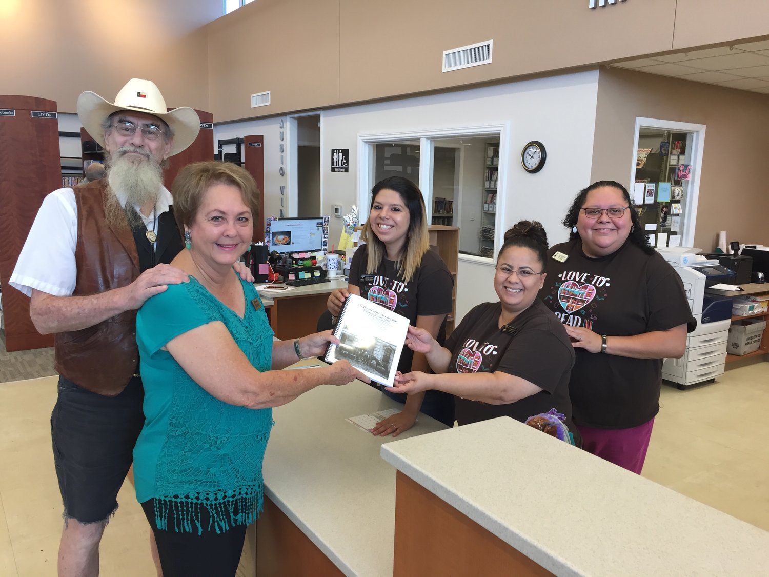 Dr. David M. Horton and Sandra McGinty Wolff present Robert Lee Brothers Jr. Memorial Library employees with a copy of their new book “The History of the 1854 and 1885 Gonzales County Jails.”