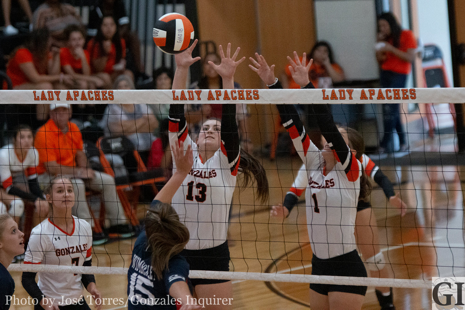Hayley Sample (13) and Sam Barnick (1) go up for a block.