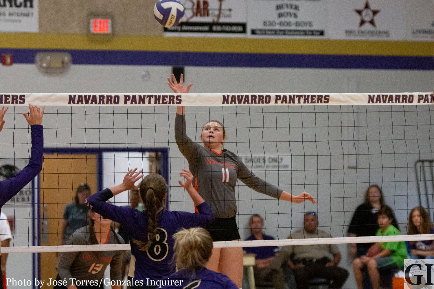 Madelynn Brown (11) comes away with a kill in Gonzales’ four-set loss to Navarro.