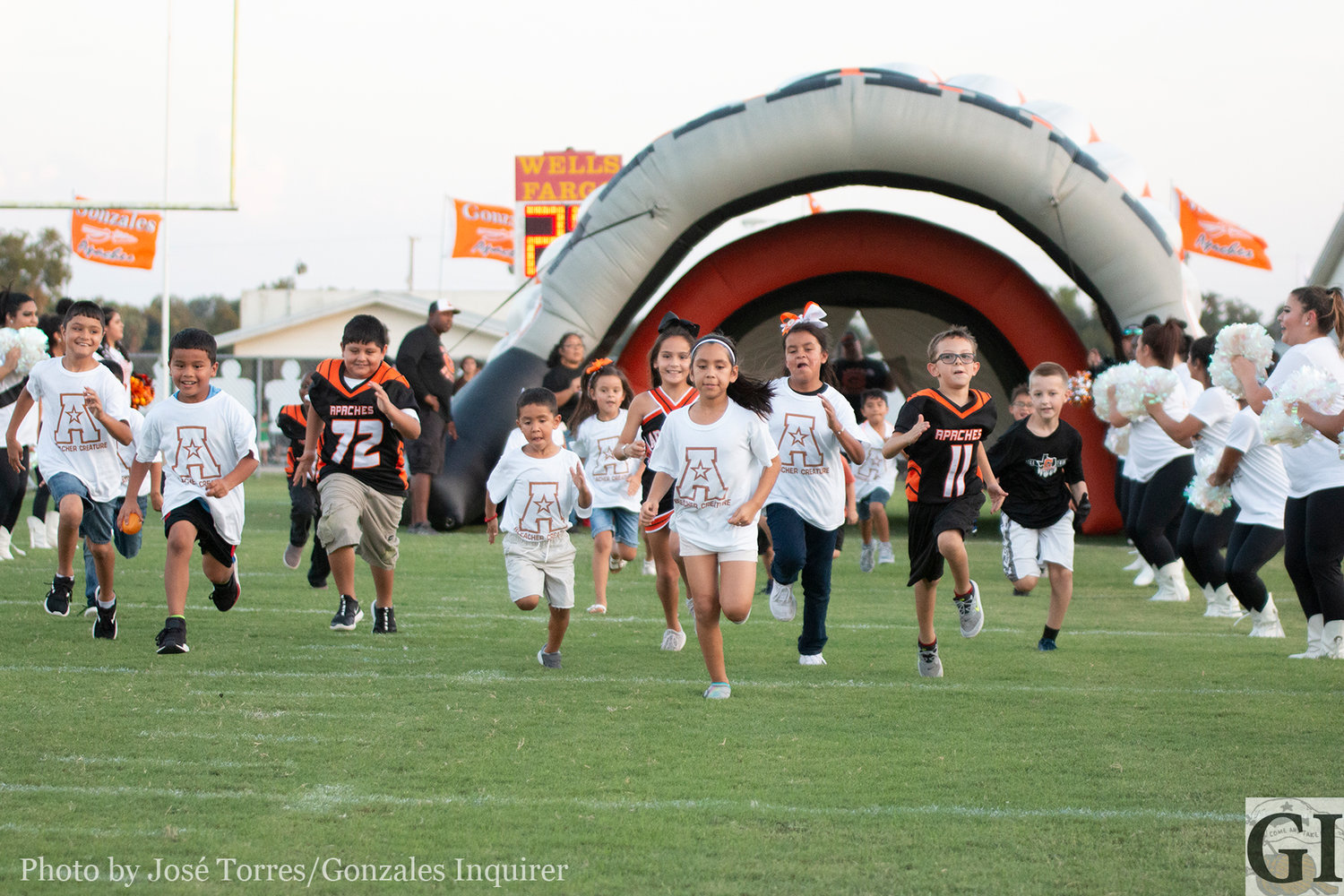 The Gonzales "Bleacher Creatures" run through the tunnel before kickoff at Apache Field.