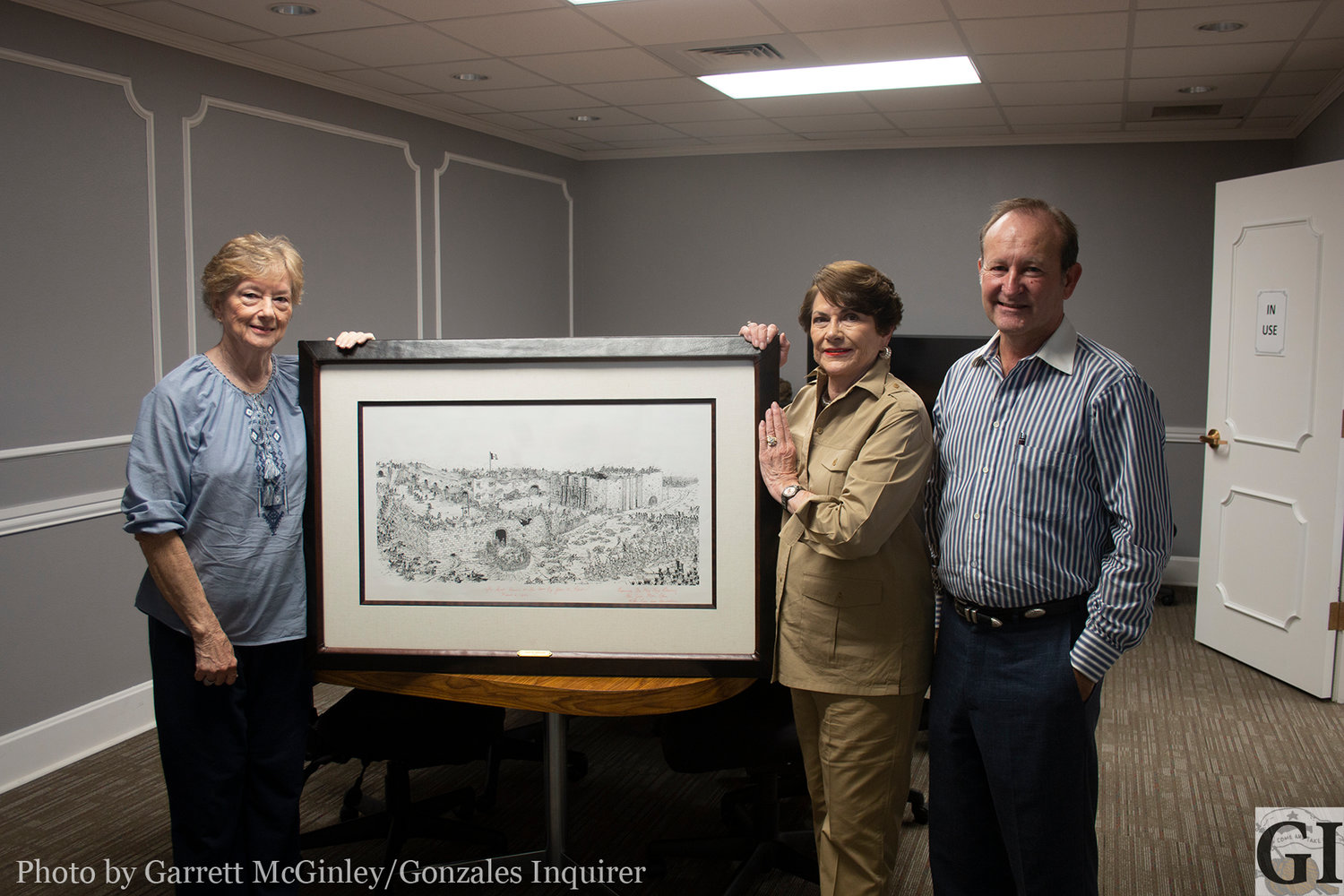 Clint Hille, Carol Eakman and Library Board President Vicki Frenzel pose with the James Robertson drawing donated by Rex Bushong on behalf of his late wife Vickie.