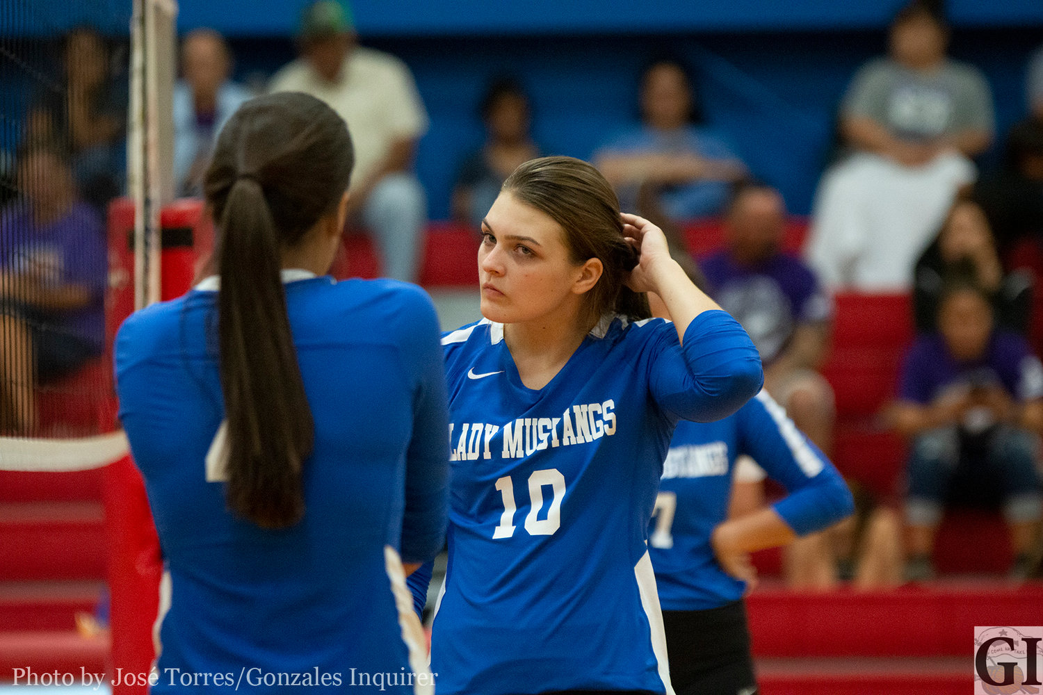 Katy Tschoepe (10) talks strategy with her teammate.