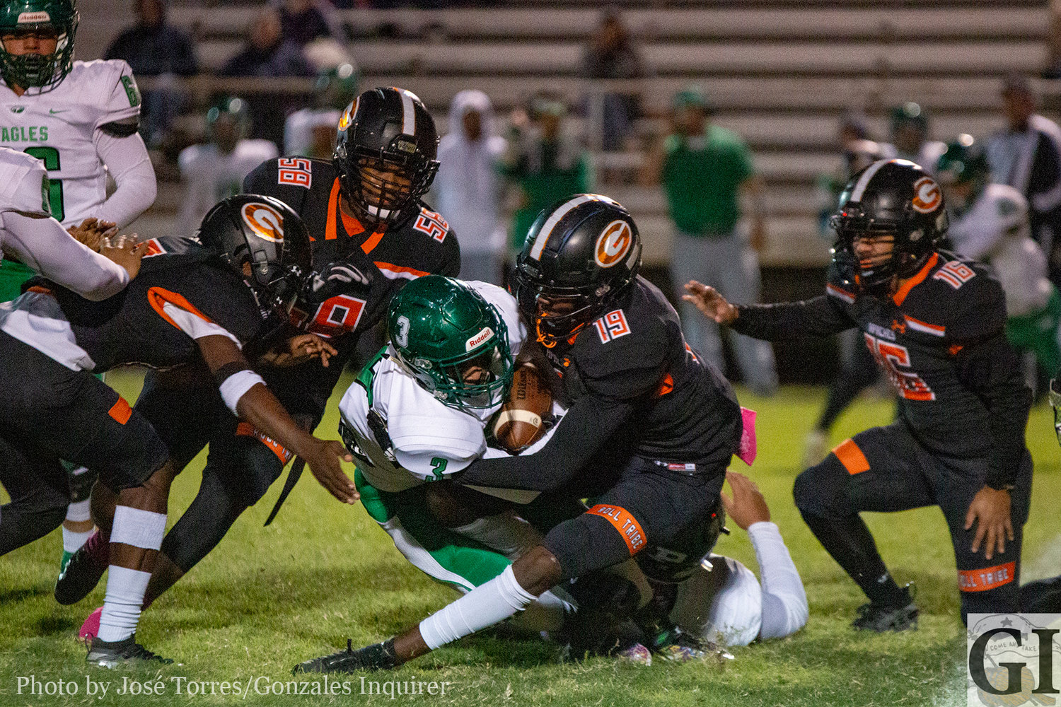 A group of Apache defenders surround Pleasanton in Gonzales' 20-13 district victory on Friday.