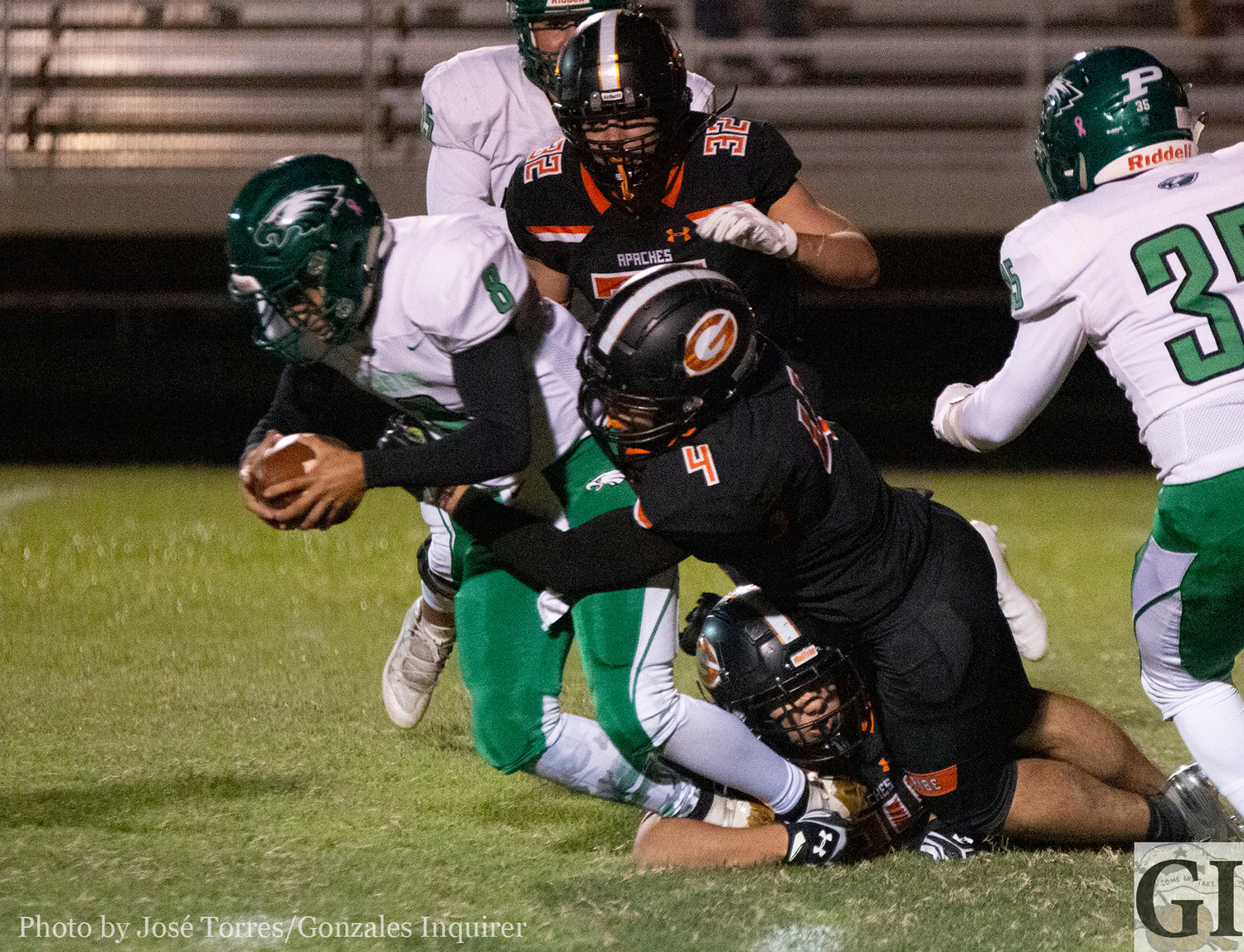 Lion Williamson (4), with the help of Zachary Box (24) down low, came up with a sack early in the third quarter in Gonzales' 20-13 victory over Pleasanton.
