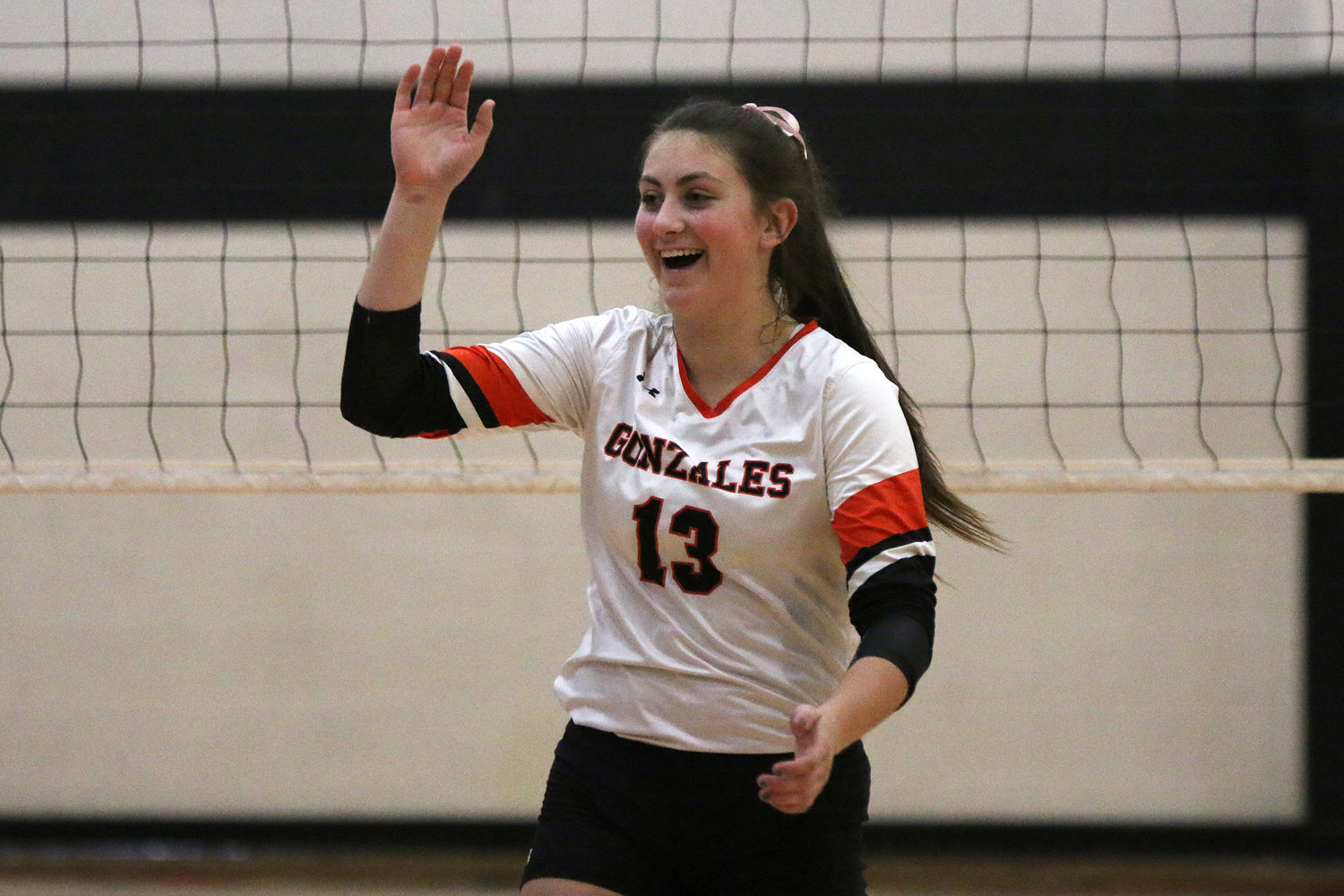 Hayley Sample (13) celebrates a kill in a district win over San Antonio Brooks Academy in October. Sample was named to the District 30-4A first-team all-district list.