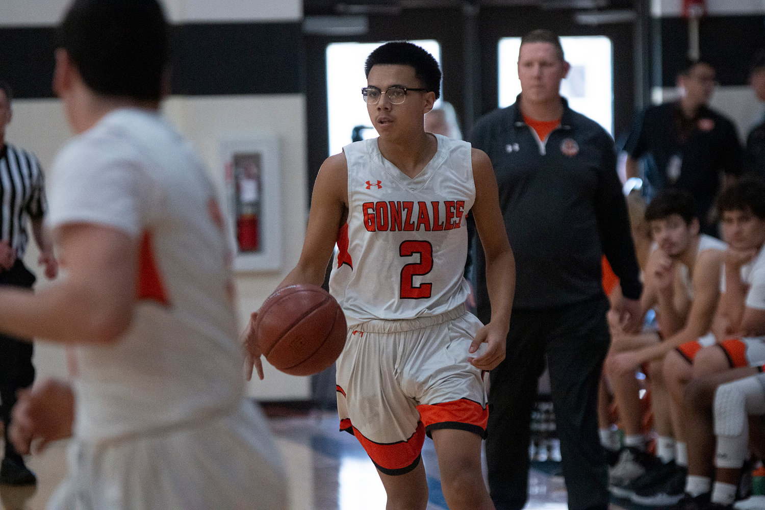 Xavier Aguayo (2) dribbles down the court in their 61-57 victory over Yorktown last Friday. The Gonzales Apaches won all four of their games to take first place in their home tournament.