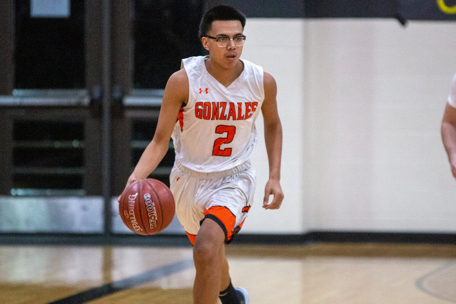 Xavier Aguayo (2) dribbles down the court in Gonzales’ 69-59 victory over Poteet at home.