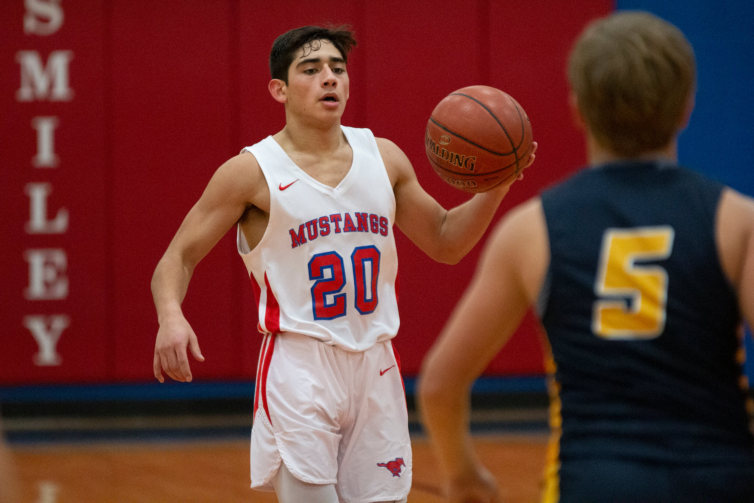 Santos Pompa (20) dribbles down the court in Nixon-Smiley’s 53-33 loss against Poth. He ended the night with two points.