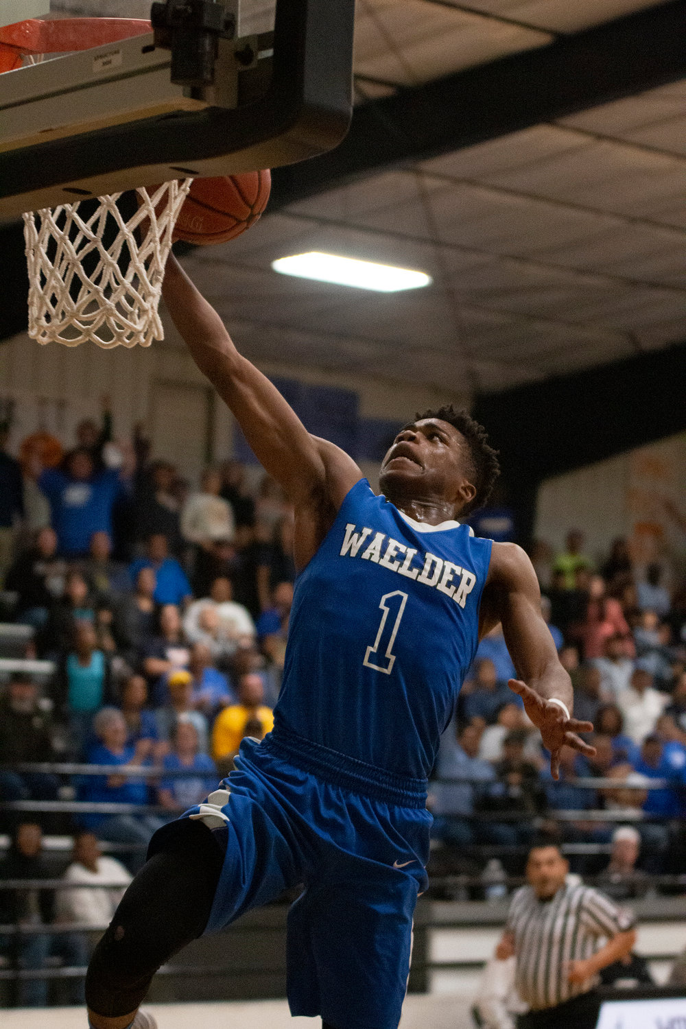 Isaiah Miller (1) finishes a fast break with a dunk in Waelder’s 61-43 win over Moulton on Tuesday. The Wildcats are now 9-0 in District 30-1A.