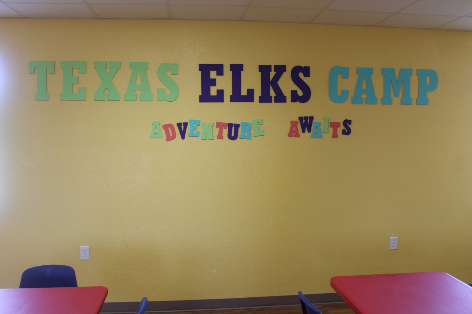 The lettering on the wall greets all camp attendees in the dining hall.
