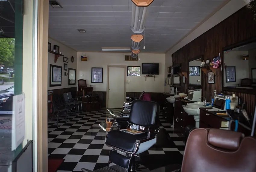 The San Marcos Barber Shop and other Texas salons can reopen Friday as long as hairstylists work with only one customer at a time and customers maintain a 6-foot distance from one another.