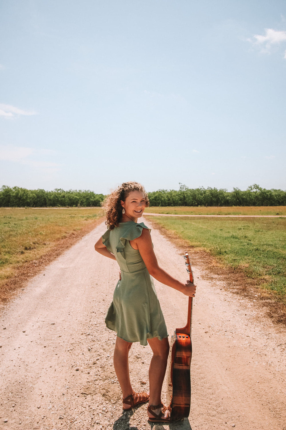 Although not at the crossroads, Grace Morgan, with her acoustic guitar, performs a rendition of a song that is about anything but a one-way street.