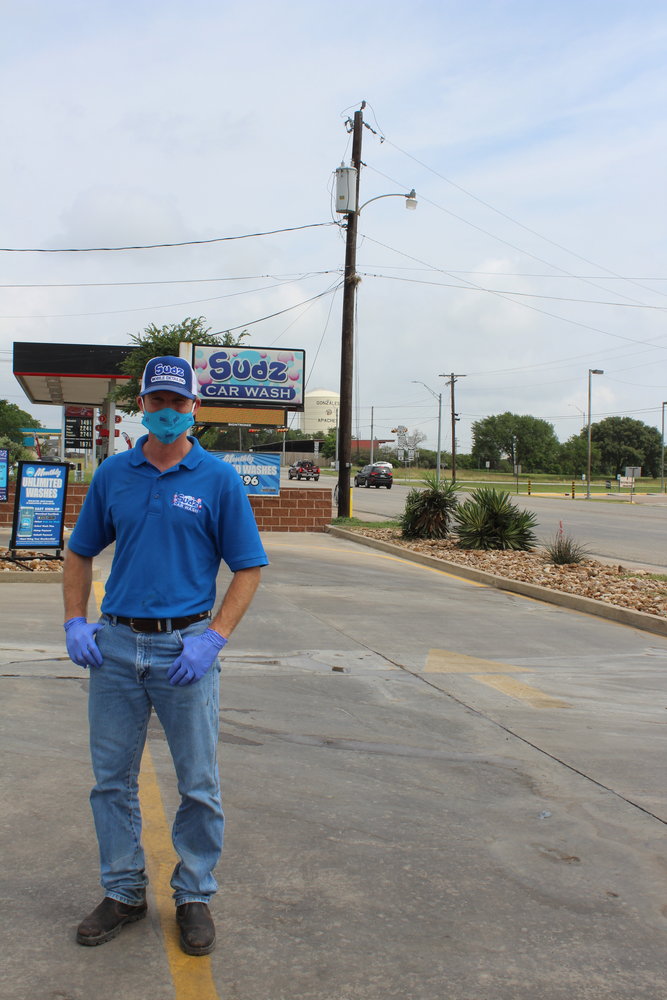 Standing in front of his sign is Craig Golham, owner of Sudz Car Wash, who took on the task of supplying Gonzales hospital workers with free cleanings as his way of giving back to the healthcare community.