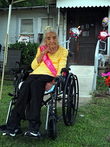 Maria De Jesus “Jesusa” Almaraz watches as a parade goes by in celebration of her 103rd birthday on June 1.