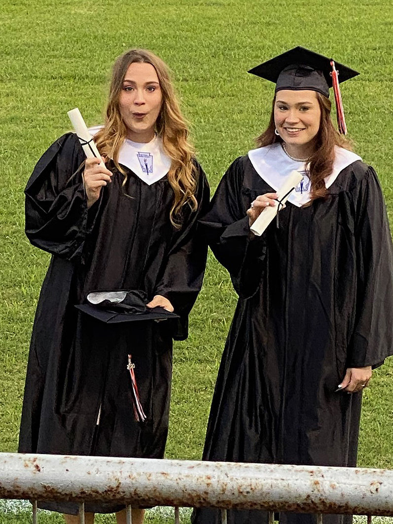 Johnna Dalton and Tyla Dalton show off their diplomas Friday night at graduation.