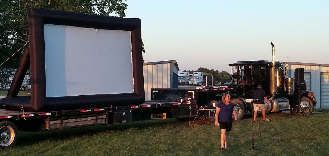 The giant inflatable screen is prepared for the drive-in movie night in Smiley.