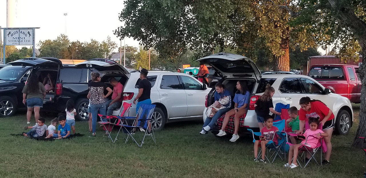 Families gather for a drive-in movie night last Friday in Smiley.