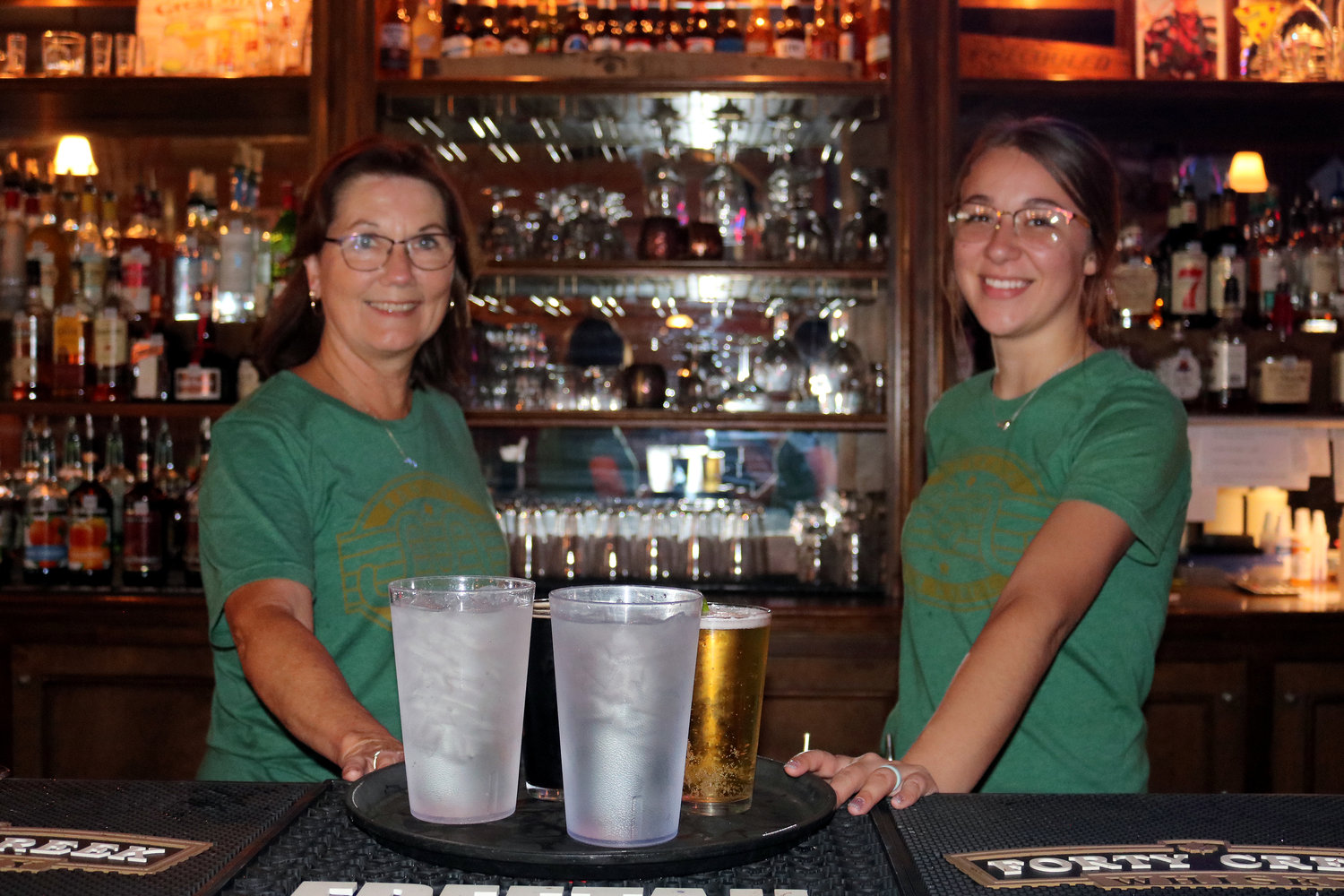 Happy to be of service at the Running M Bar & Grill are owner Marlene Metzler, left, and waitress Cameron Cardona.