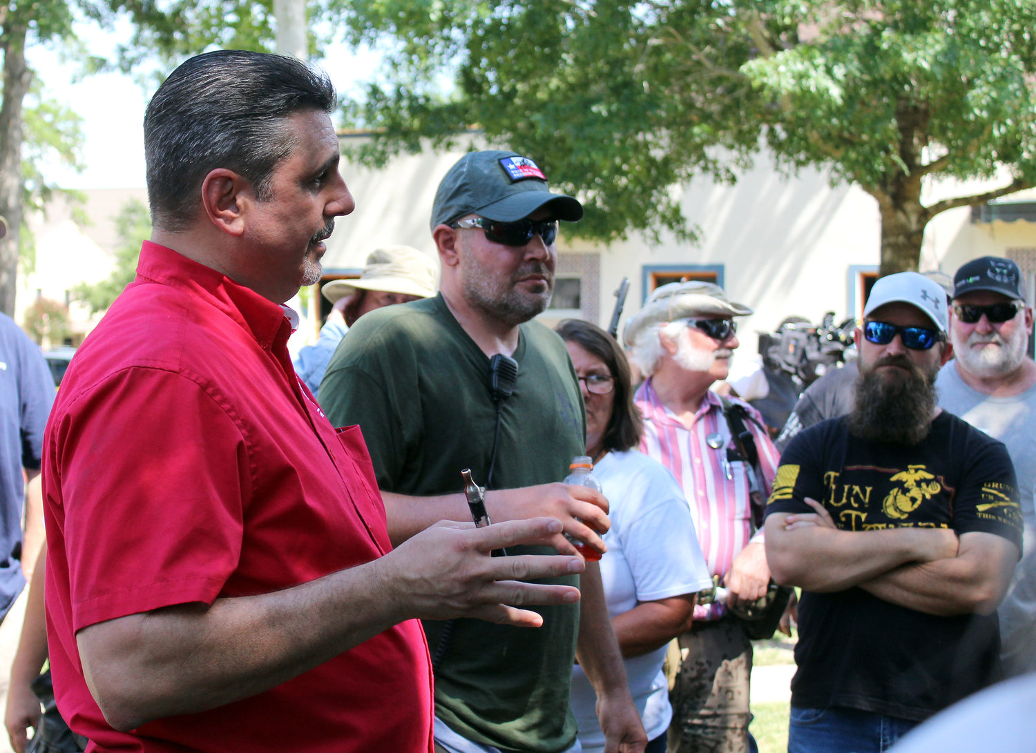 David Amad, left, of Open Carry Texas, and Brandon Burkhart, president of This is Texas Freedom Force, address their gathering Friday afternoon in Confederate Square.