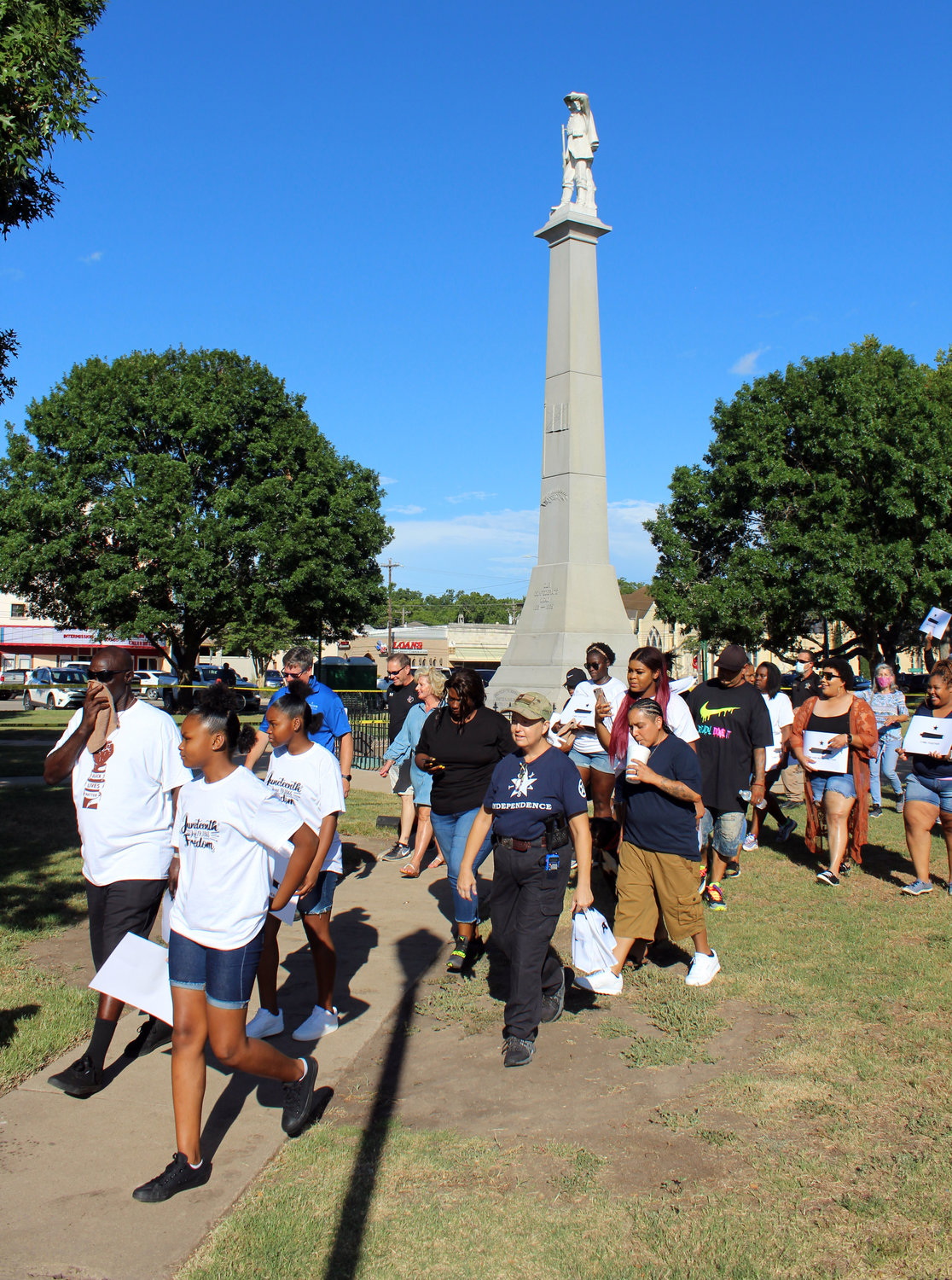 Juneteenth celebrators march out of Confederate Square Friday evening headed to City Hall to hold the event there.