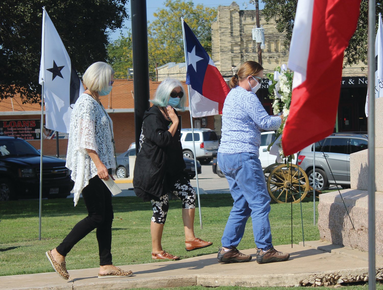 Carla Hornseth, Carole Dahlberg and Candy Allen, as new members of the Daughters of the Republic of Texas, placed a memorial wreath at the base of the monument in Texas Heroes square.