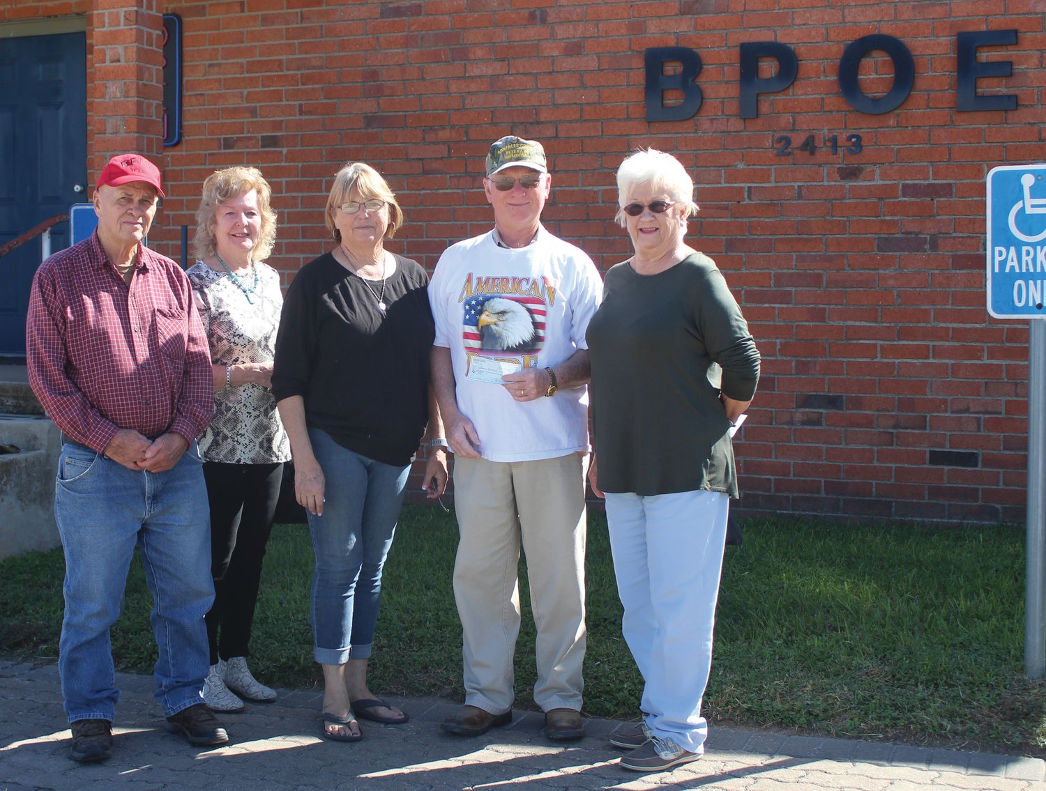 Presenting and representing First Shot Cookoff-Elks, with a donation of $1,500 to Veterans Memorial are Joe Kotwig, Mary Ann Day, Lori Behlen and Shirley Breitschopf. Accepting the check for Veterans is Larry Mercer.