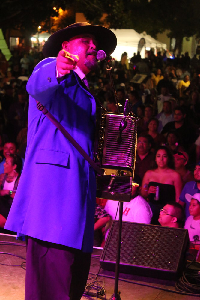 Oscar Garcia of Los Garcia Brothers plays up to the camera during his group’s headlining performance Saturday night at Come and Take It Celebration in Gonzales. A large crowd was present to see and hear the Conjunto superstars play all of their greatest hits in their classic zoot suits.