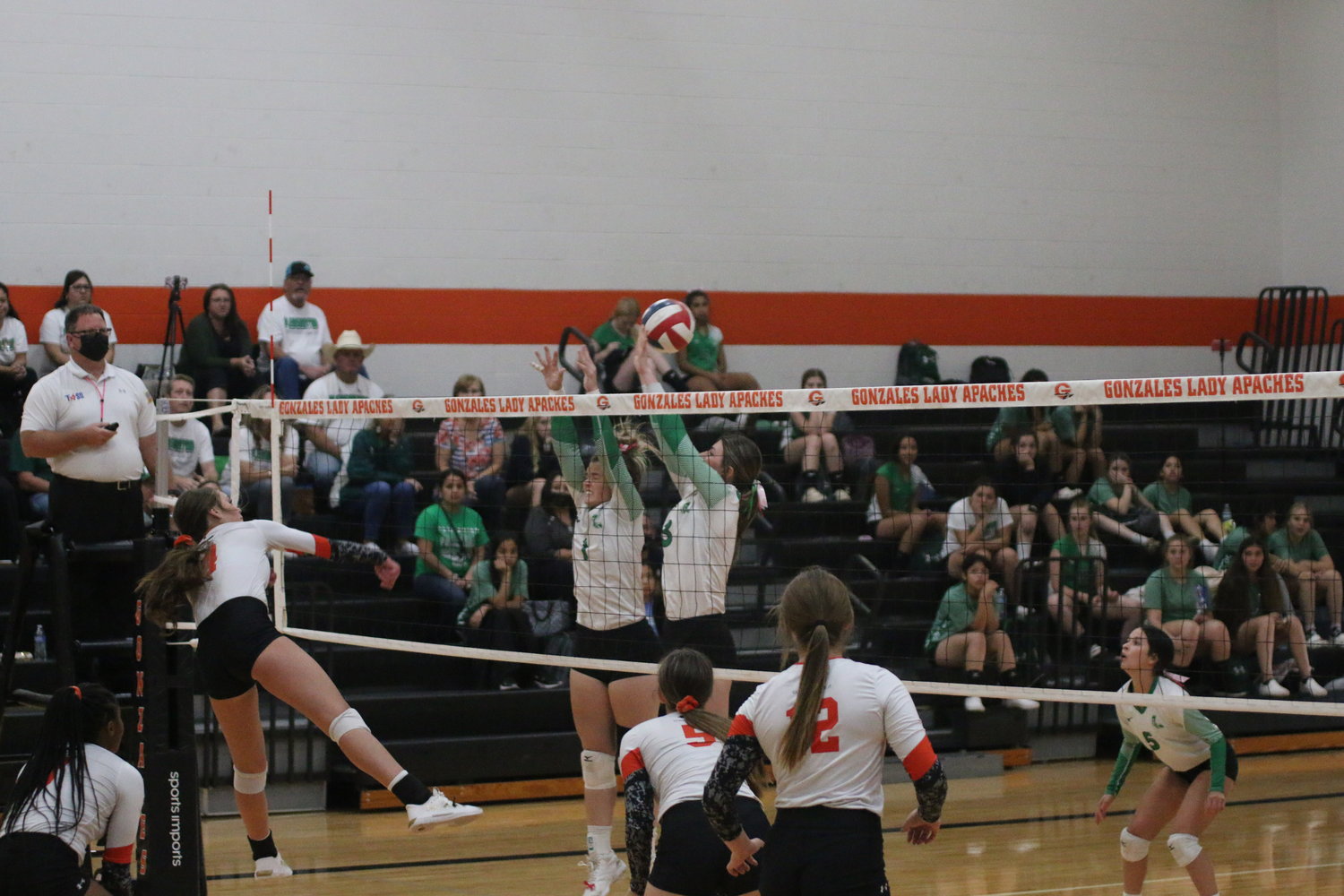 Mckenzie Hodges (4) gets one of her team-high 11 kills off a Pleasanton block attempt with support behind from Maddy York (8), Sydney McCray (5) and Macy Sample (12).