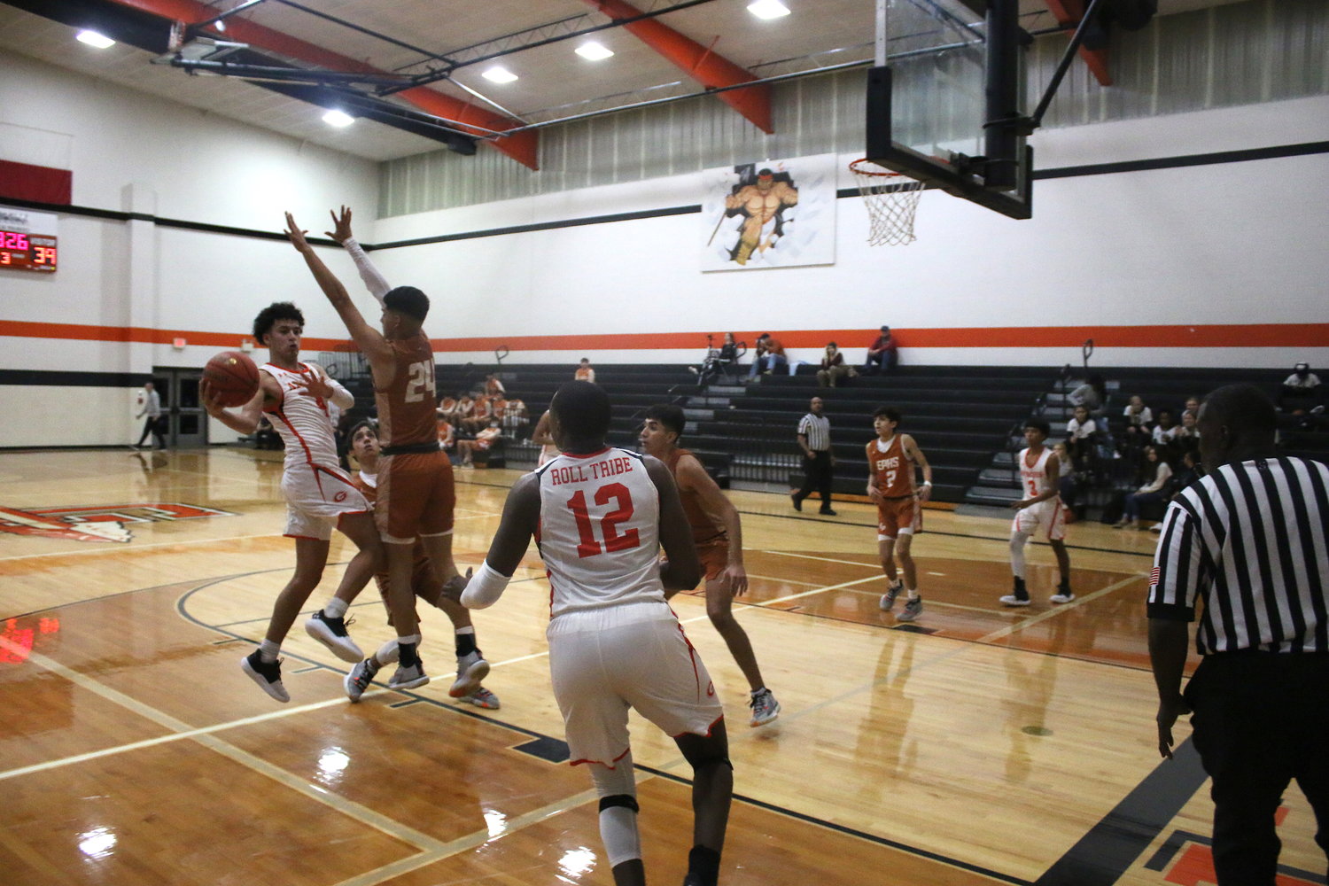 Angel Martinez (4) dishes an assist to Jeremiah Hastings (12) during the third period of Gonzales' 58-56 come-from-behind victory over Eagle Pass at home on Tuesday, Dec. 7.