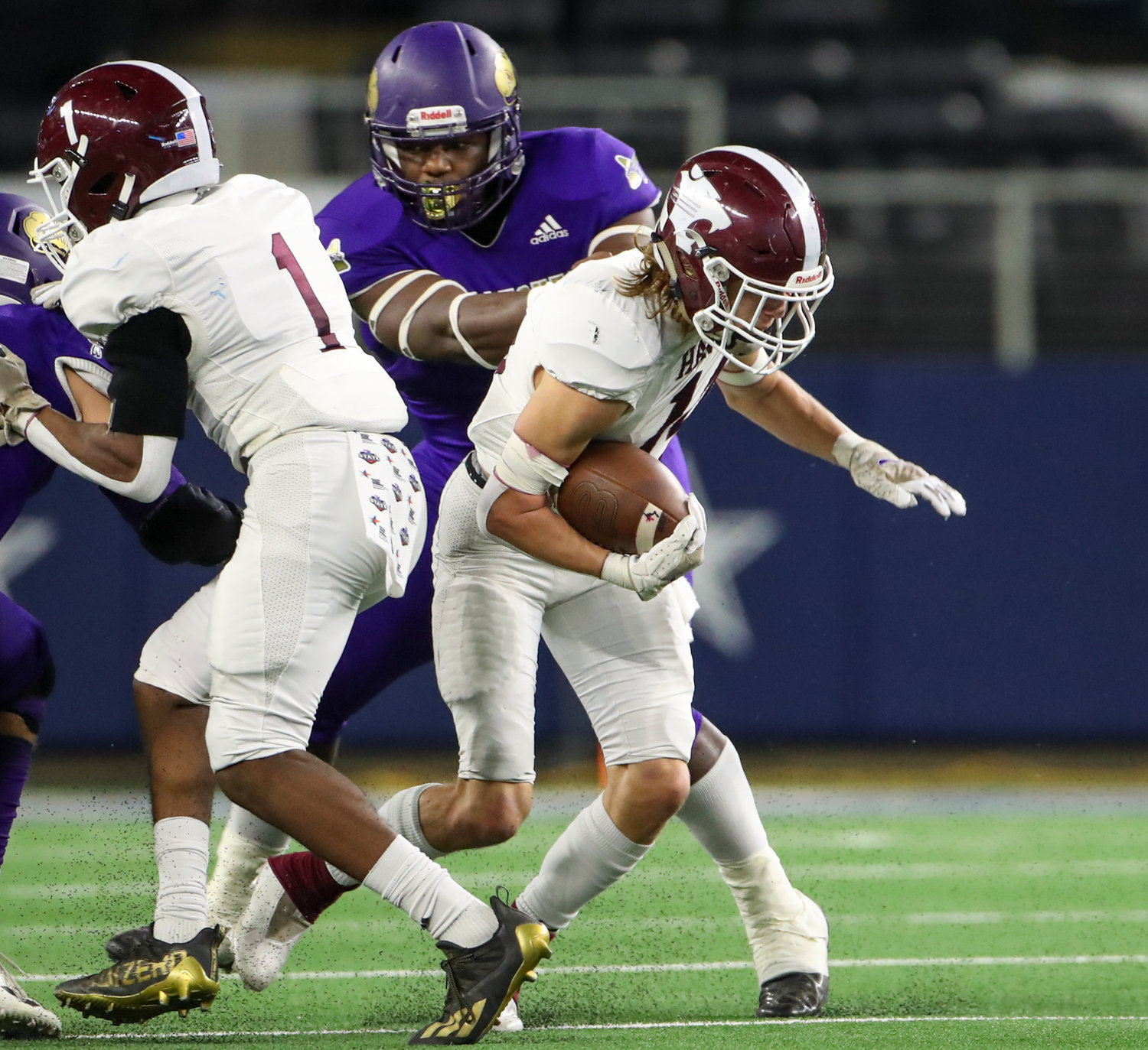 Shiner Comanches senior Doug Brooks (1) wraps up Hawley Bearcats junior Austin Cumpton (12) for a sack during the Class 2A Division I state football championship game between Shiner and Hawley on December 15, 2021 in Arlington, Texas.