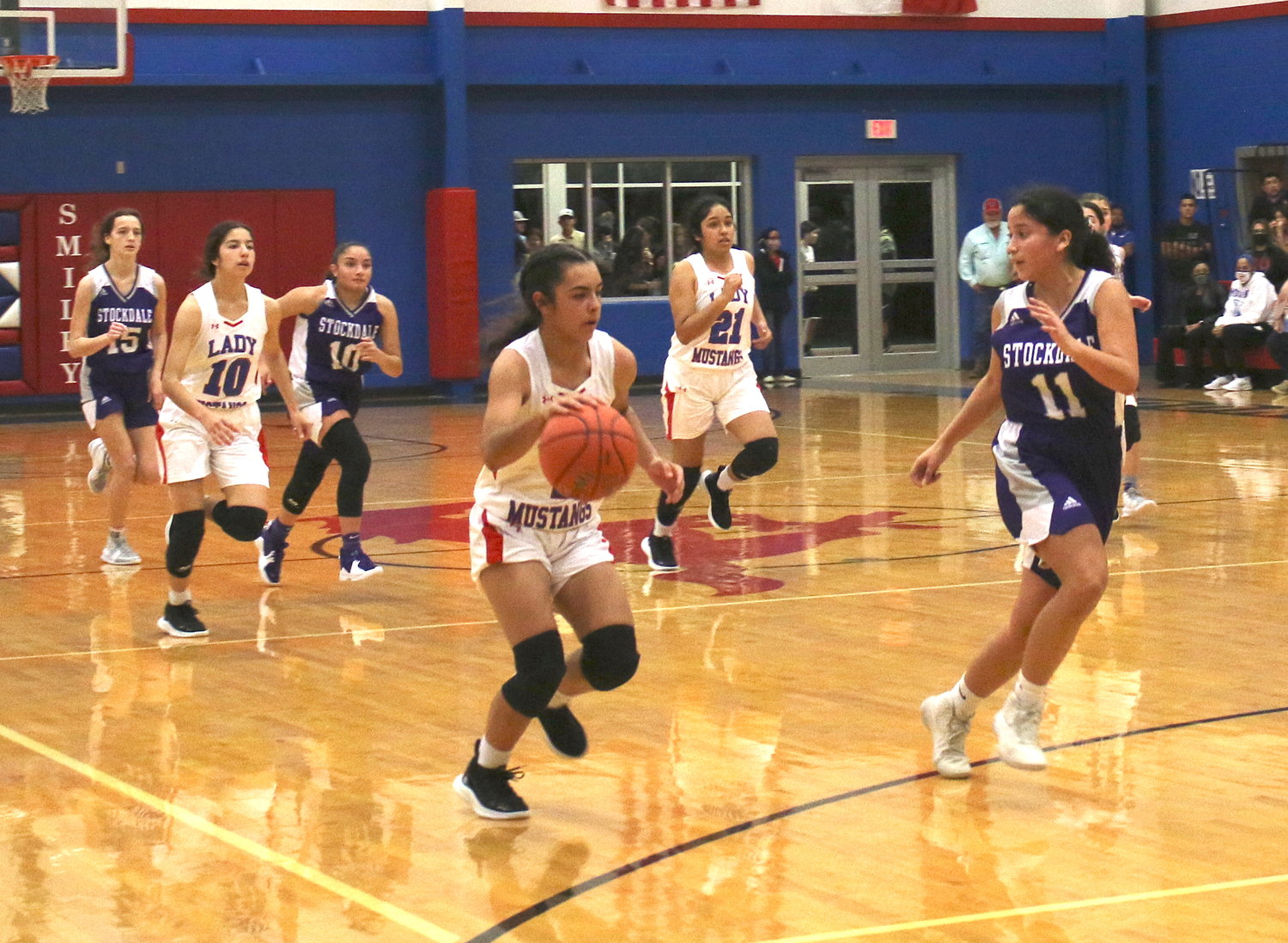Mady Velasquez brings the ball down court on a fast break, followed by Ariel Villanueva and Deanna Amaya against Stockdale. Velasquez scored three points against Cole.