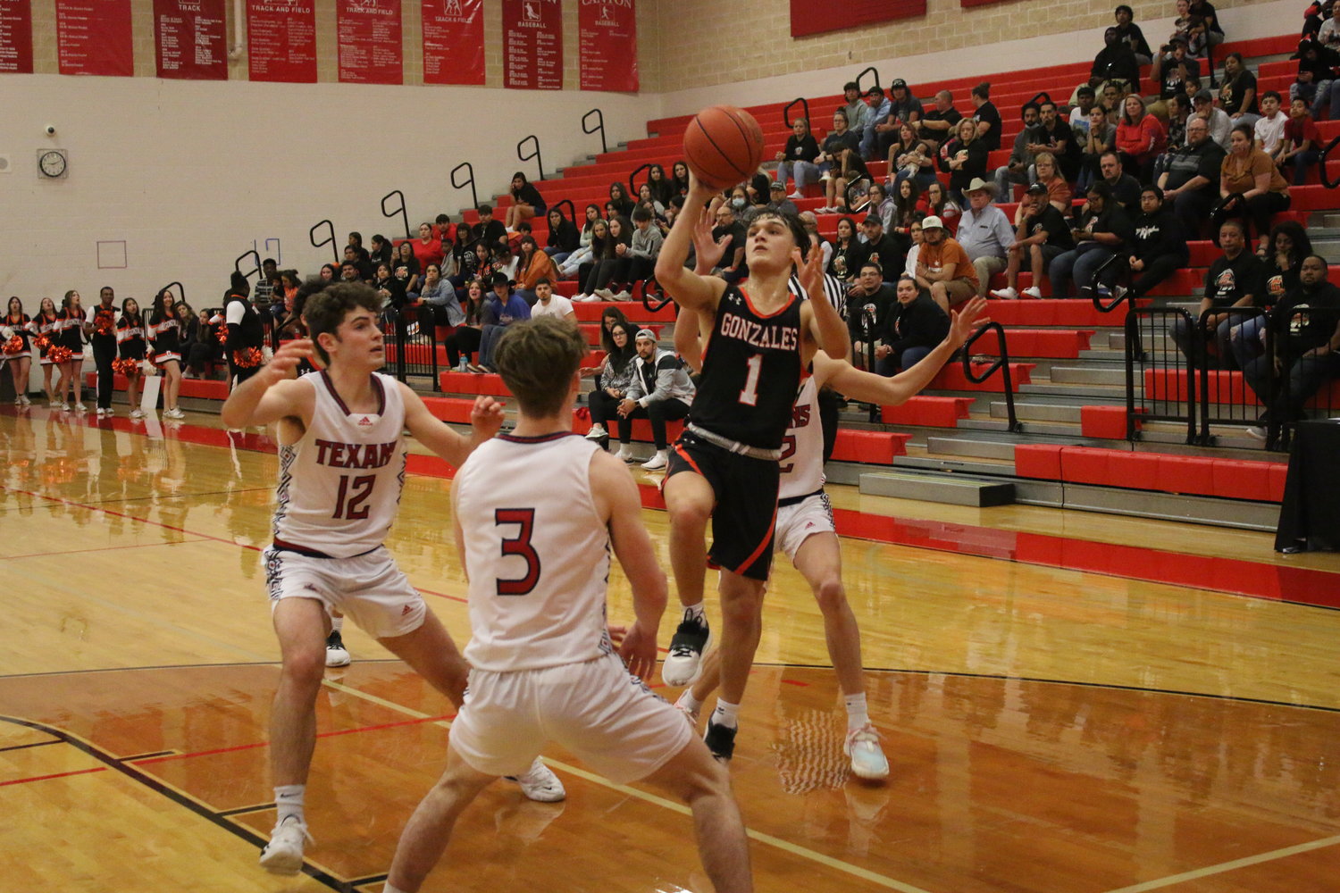 Senior Brady Barfield puts up a shot on a drive against the Texans in Tuesday’s bi-district playoff game. Barfield scored 15 points and hit four three-pointers in the game.