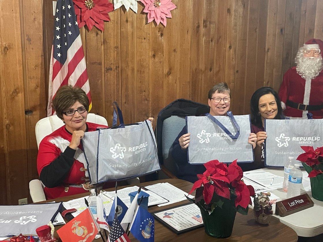 Members of the Smiley City Council show off the swag bags they received from Republic Services at the Wednesday, Dec. 21, council meeting. The city voted to continue their contract for waste management with Republic Services and announced residents could see a $10 increase in monthly utility bills due to higher costs.
