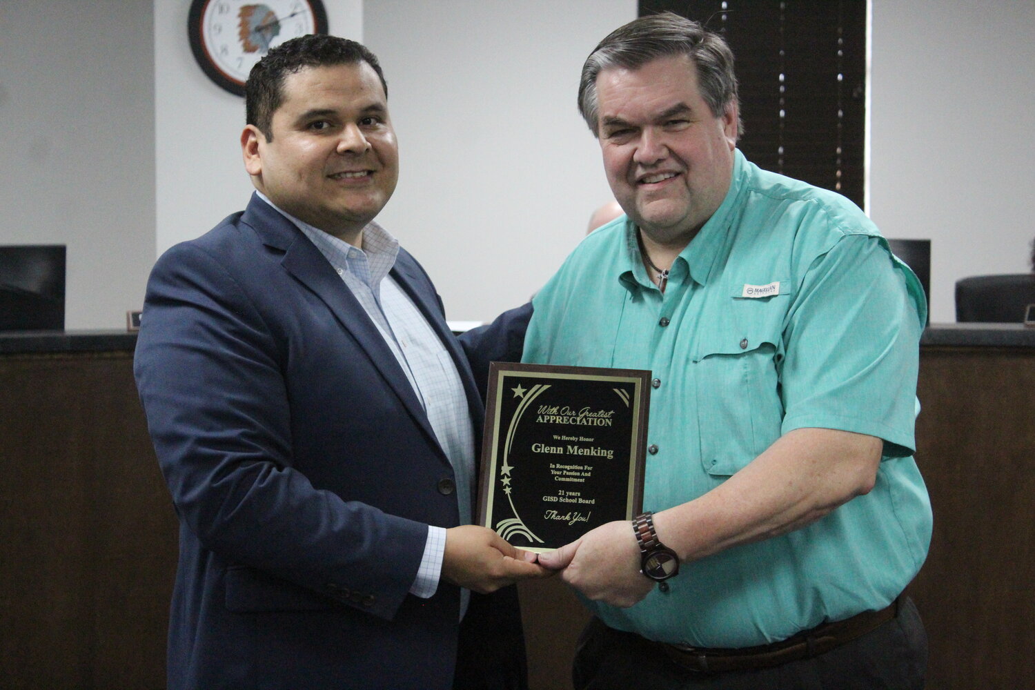 Gonzales Superintendent Dr. Elmer Avellaneda presents a plaque to outgoing school board member Glenn Menking for his 21 years of service on the school board. Menking served with six superintendents and more than 15 school board members during his 21 years on the board.