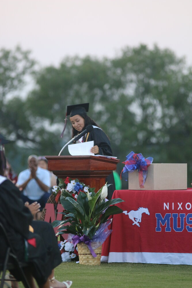 Nixon-Smiley valedictorian Cecilia Villasana checks over her graduation speech before addressing the audience Friday, May 26 at Mustang Stadium.