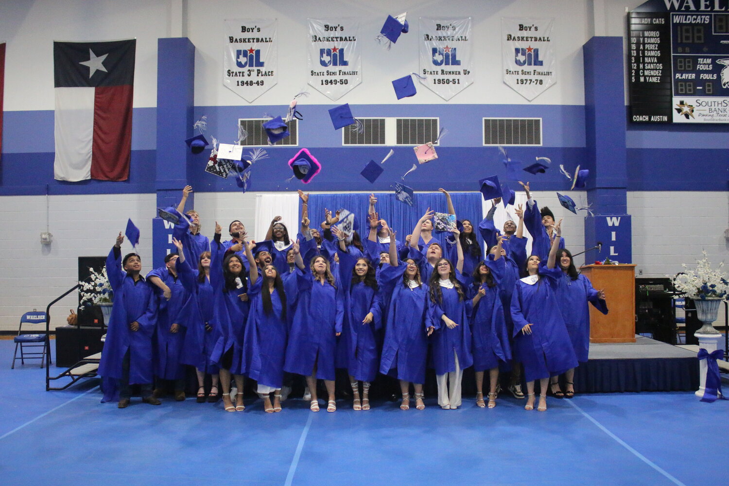 The Waelder High School Class of 2023 toss their caps into the air Saturday, May 26, to culminate graduation exercises at the gymnasium.