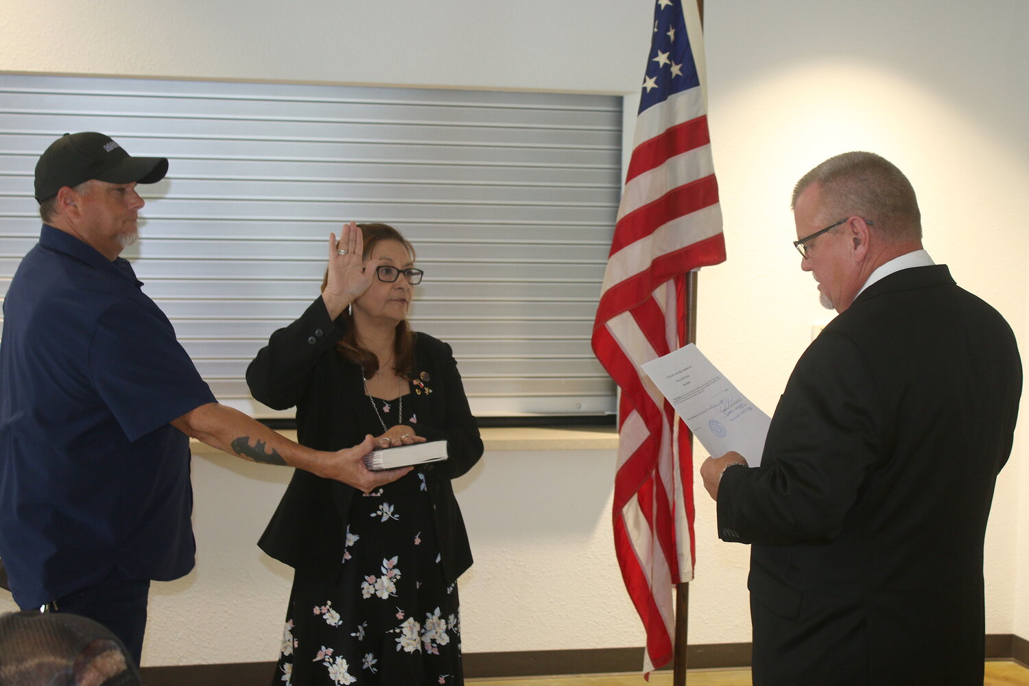 Nixon Municipal Judge and Precinct 4 JP Darryl Becker administers the oath of office to incoming City Council member Patsy Vigil Scherrer as she keeps her hand on a family Bible on Monday, June 5. Scherrer was elected last month and took her place on the council dais.