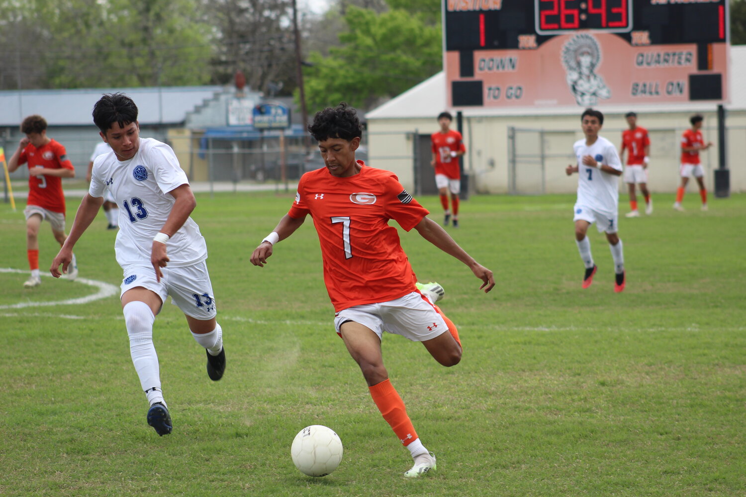 Apaches Enrique Reyna (7) and a San Antonio Memorial player chases after the soccer ball in the final match of the season.