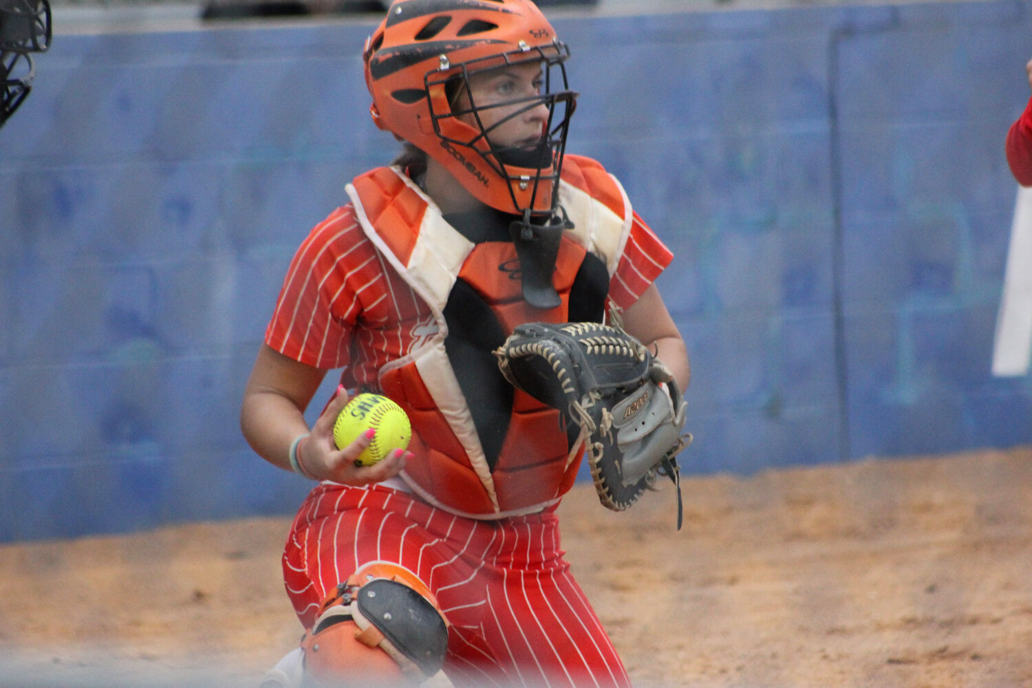 Gonzales catcher Sydney McCray (3) catches the ball from pitcher Haley Cantu in the district match against San Antonio Memorial Tuesday, March 19.