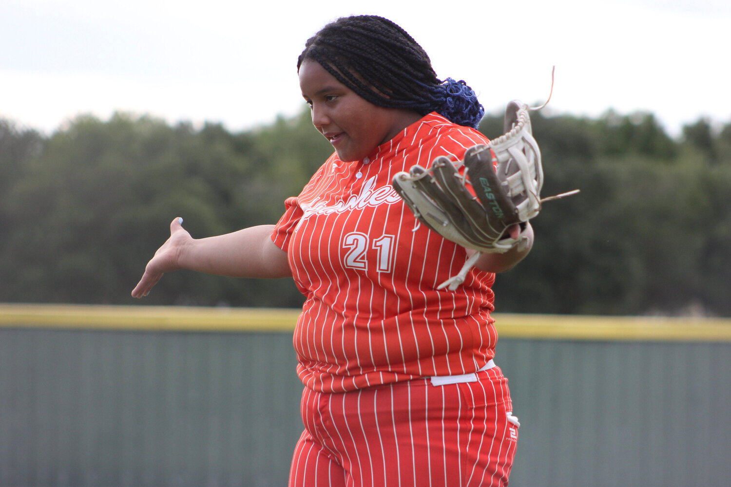 Lady Apaches Keiryah Greathouse (21) warms up against the Shiner St. Paul Cardinals Monday, April 22.