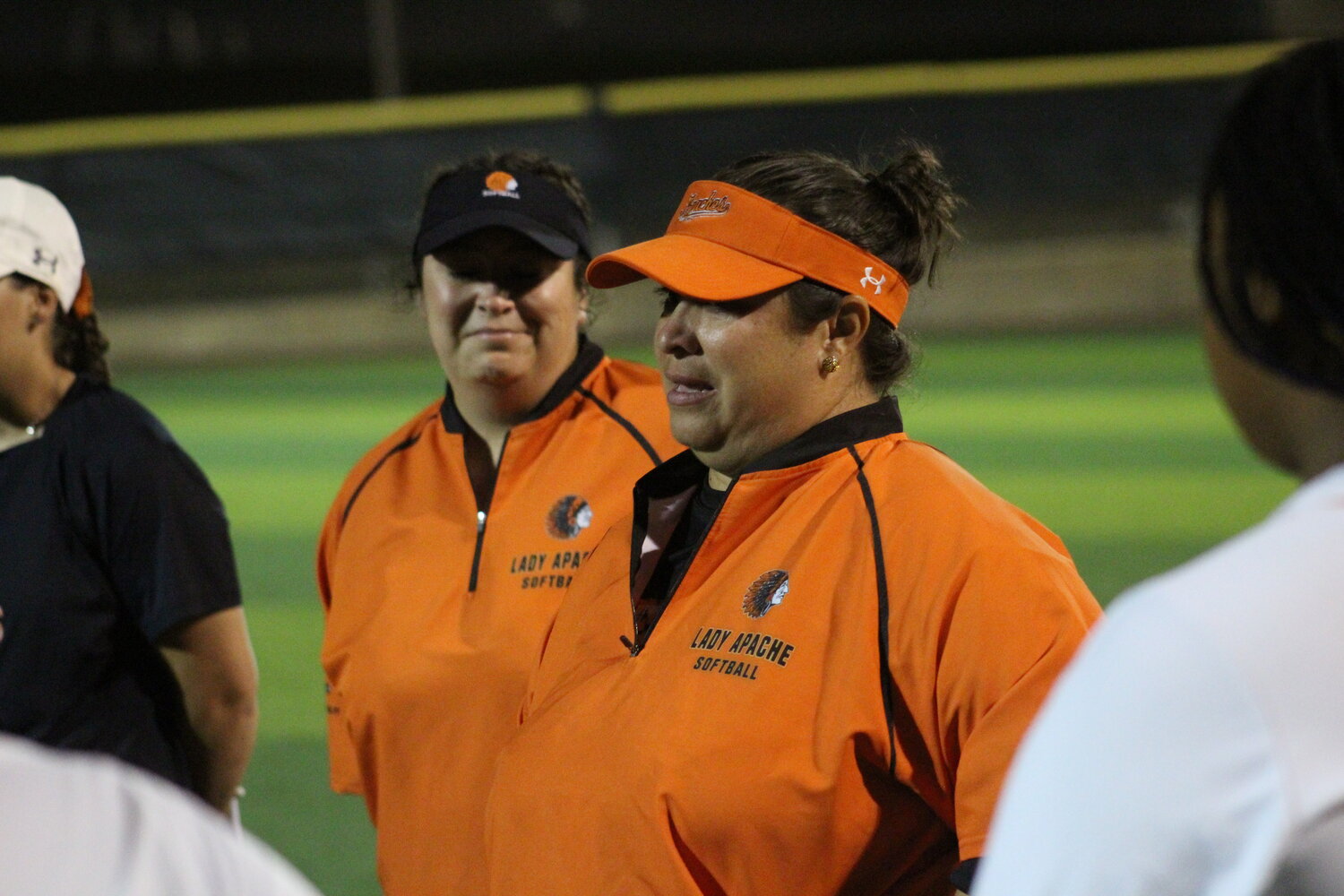 Lady Apaches head softball coach Michelle Uribe speaks to her players after the area round loss to Needville. Uribe in her second year turned the Lady Apaches from 9-22 (4-6 fourth place district) to a 21-10 (7-3 second place district) team.