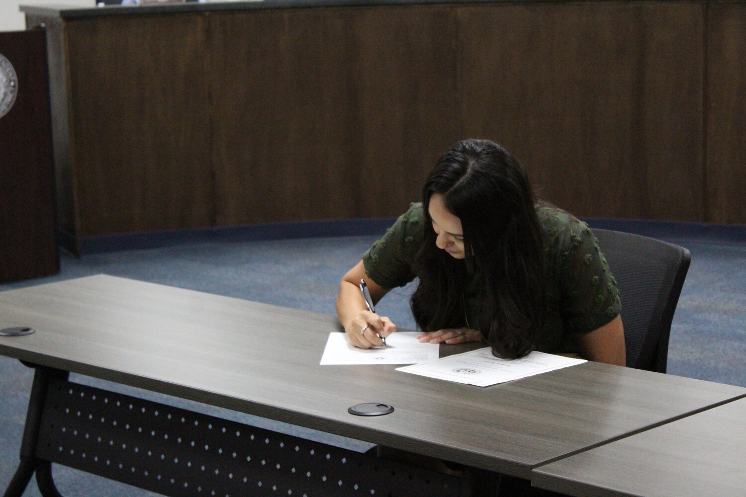 New elected school board member Naomi Brown signs her official document as the representative of District 7